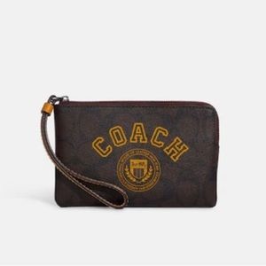 Coach Corner zip wristlet in signature canvas with varsity motif